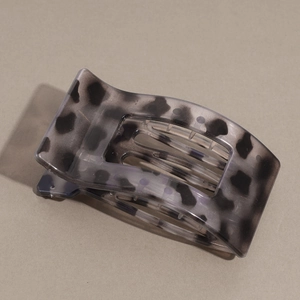 Flat hair claw clip featuring grey leopard print design with curved teeth detail
