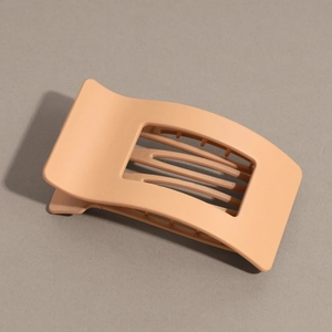 Close-up detail of the smooth matte resin texture and spring claw design of this hair clip