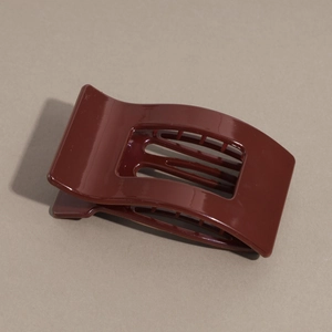 Detail view of the glossy burgundy flat hair claw clip with a hollow rectangular design