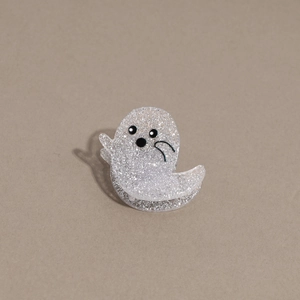 Detail view of mini Halloween ghost hair clip with glitter finish and cute cartoon face