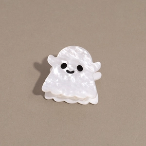 Close-up of white acetate ghost hair claw clip with pearlescent finish for Halloween