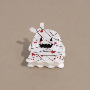 Detail of mummy ghost hair claw clip made of white acetate for Halloween styling