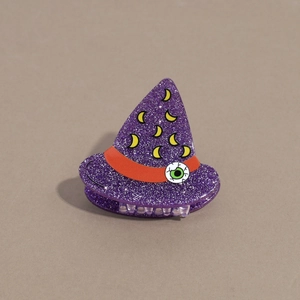 Detail of purple glitter wizard hat hair claw with orange band and spooky eyeball
