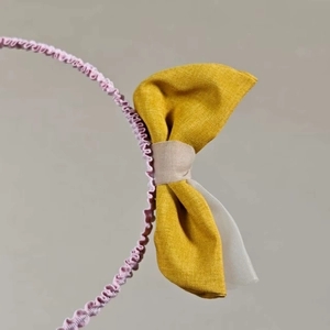 Stylish mesh bow headband with pink wavy fabric and yellow rabbit ear accents