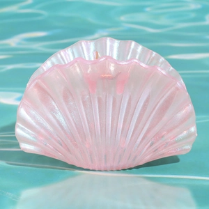 Pinza per capelli a conchiglia rosa perlato con trama in acrilico scintillante su acqua