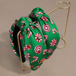 Green fabric headband with candy cane print, holiday knot, and colorful rhinestones