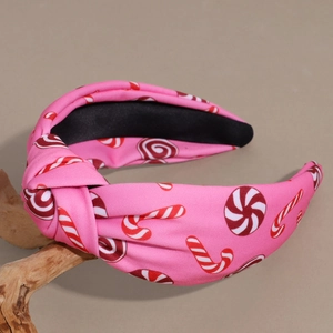 Detail of pink fabric headband with candy cane patterns and a stylish top knot