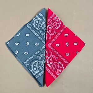 Detailed macro view of red and blue paisley patterns on folded cotton bandana fabrics