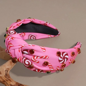 Detail of pink knotted headband with candy prints and sparkling rhinestone embellishments