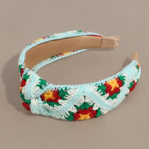 Detailed macro view of the light blue crochet flower headband with a knit knot design