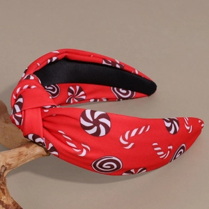 Close-up of red and white knotted headband featuring candy cane prints and soft texture