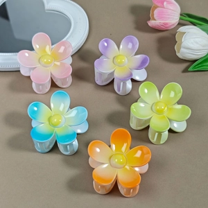 Detailed view of five gradient macaron flower hair claws for women in soft pastel tones