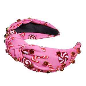 Pink fabric twisted headband with festive candy print and sparkling colorful rhinestones