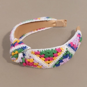 Close-up of colorful crochet knit headband with stylish knot and golden satin lining