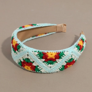 Detail of colorful floral crochet headband featuring intricate handmade knit patterns