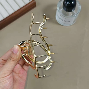 Elegant gold alloy wave hair claw clip with a hollow design for stylish hairstyling