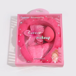 Detailed pink spa headband and wristband set with a flower clip and makeup sponge in a gift box