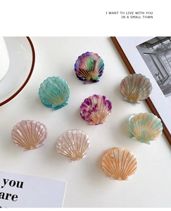 Detailed set of 8 shell-shaped acetate hair claws with elegant golden lined patterns