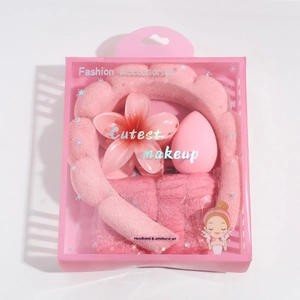 Pink plush headband with wristbands and flower hair claw clip in a gift box packaging