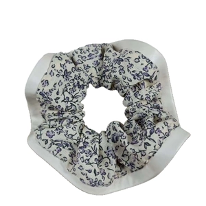 Chouchou fleuri violet avec bordure en cuir blanc pour coiffure élégante femme