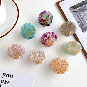 Elegant shell-shaped acetate hair claw clips with gold texture details in multi-color set
