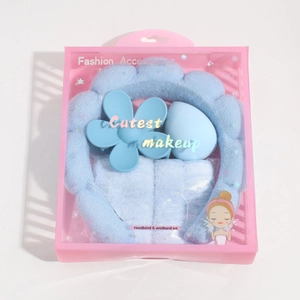 Detailed close-up of a 5-piece light blue spa headband and wristband set in a retail box