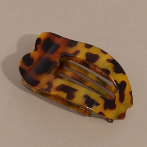 Close-up of tortoise shell pattern hair claw clip with a curved ergonomic design