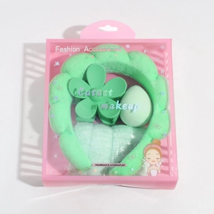 Detail of light green spa headband set with claw clip and wristbands in a gift box