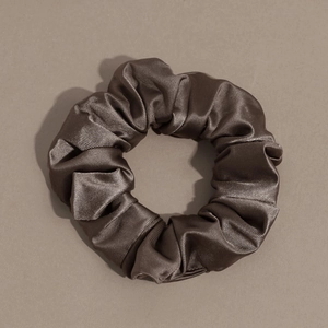 Detail of dark brown satin scrunchie showing smooth metallic silk texture and soft folds