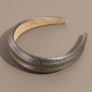 Macro detail of silver snakeskin textured wide headband with soft faux suede lining