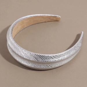 Detail shot of silver snake-patterned wide headband with textured faux leather and soft lining