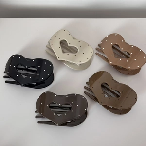 Five-piece heart hair claw clip set with white polka dots in various colors on white background