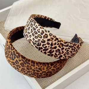 Fashionable leopard print sponge headband in two vintage patterns on a white tray