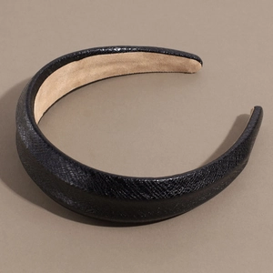 Close-up of snake pattern leather headband showing black embossed texture and beige lining
