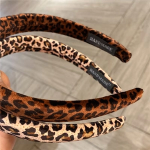 Three handmade leopard print fabric headbands in brown and gold for women