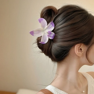 Elegant purple gradient flower hair claw clip shown on a hairstyle for a stylish look