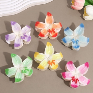 Detail view of 6-piece gradient lily flower hair claws with translucent acrylic finish