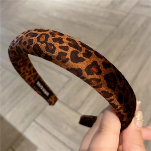 Close-up of leopard print padded headband featuring an interior handmade label tag
