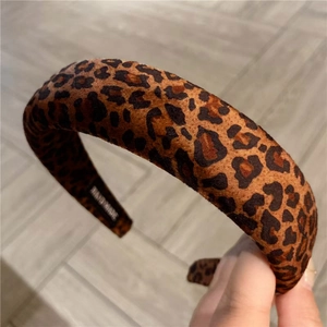 Detailed macro view of the handmade leopard print sponge headband with soft plush texture