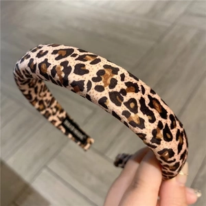 Close-up of leopard print headband showing thick padding and handmade textile label