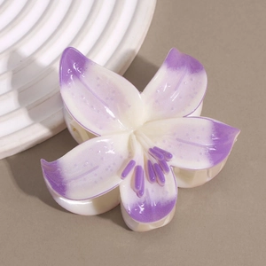 Detail of lily flower hair claw clip with purple gradient petals and glossy finish