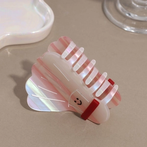 Pink and white striped hair claw clip with smiley face design and pearlescent finish