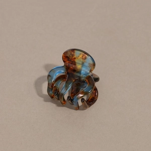 Detail of tortoise blue acetate hair claw clip with golden France Handmade lettering