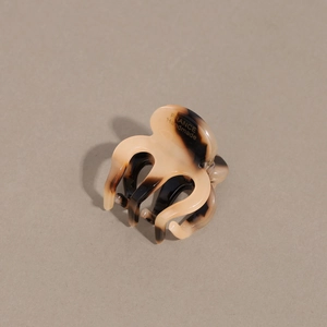 Detail view of acetate tortoise shell hair claw clip with France Handmade logo
