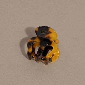 Detail of tortoise shell acetate hair claw with golden France Handmade lettering