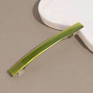 Detailed macro view of a green acetate hair clip featuring a gold France Handmade logo