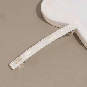Detailed macro shot of white pearlescent acetate hair clip with France Handmade lettering