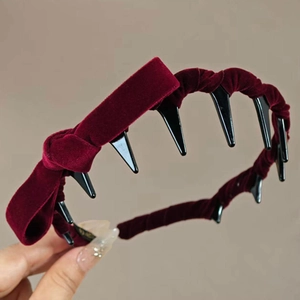 Close-up of wine red velvet headband with black integrated teeth comb for secure hair grip