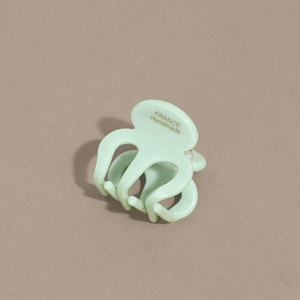 Detail of mint green acetate hair claw with France Handmade lettering and glossy finish