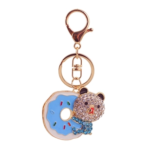 Sparkly bear with blue donut keychain featuring rhinestones and gold-plated hardware